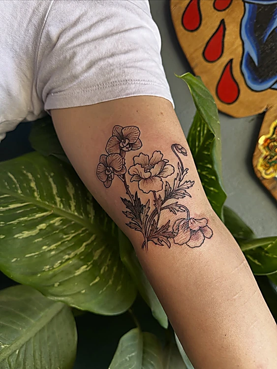 Flores en línea negra fina sobre el antebrazo